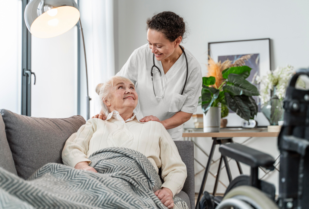 An SM24 carer with a resident in a care home lounge
